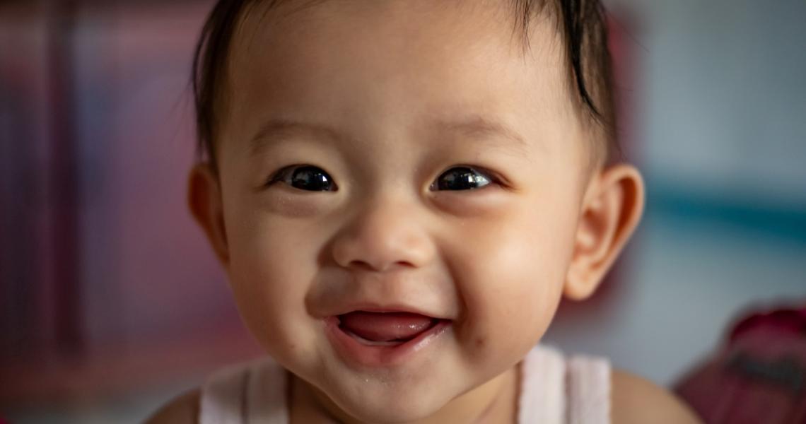 A smiling East Asian baby.