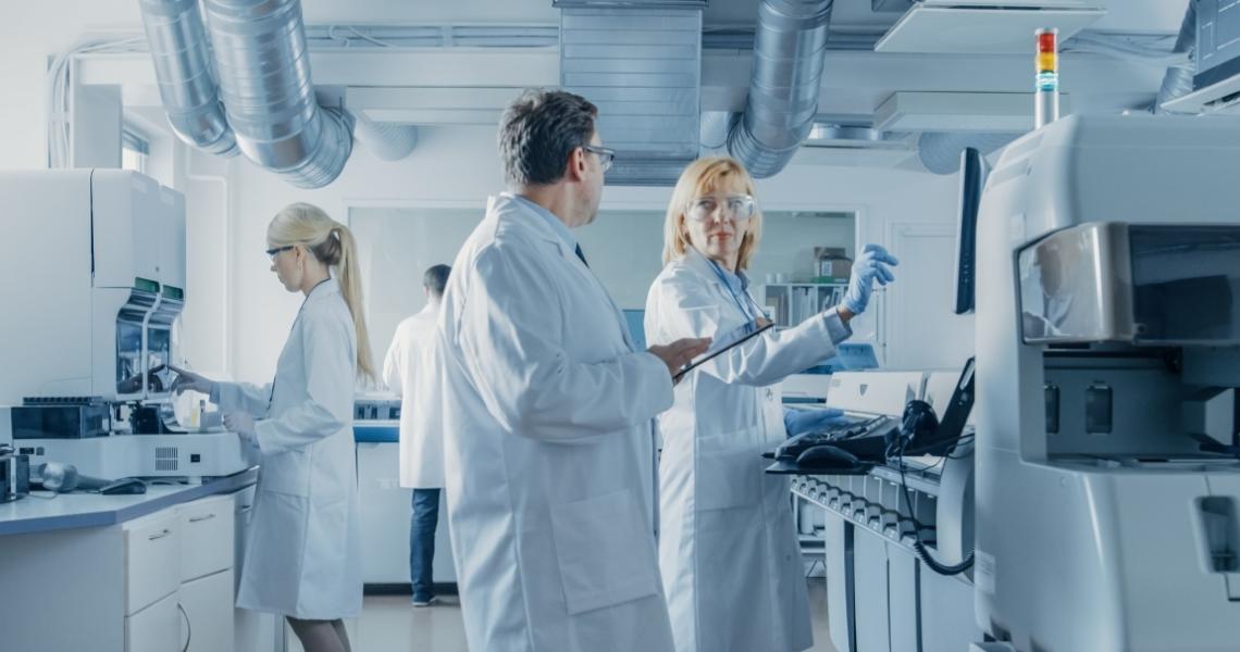 A group of scientists in a lab, representing a mix of genders.